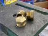 The brass plugs that were drilled and tapped.